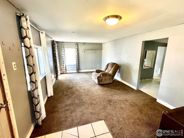 a view of front door with furniture and a window