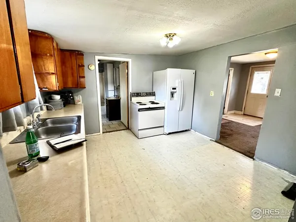 a large kitchen with stainless steel appliances granite countertop a stove sink and cabinets