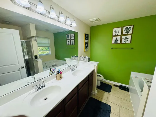 a bathroom with a sink mirror and a window