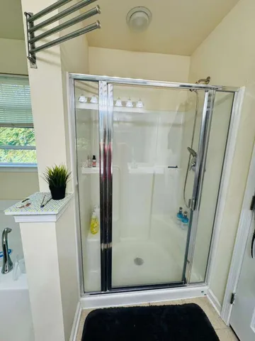 a bathroom with a shower and a sink