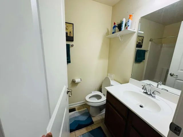 a bathroom with a sink and mirror with toilet