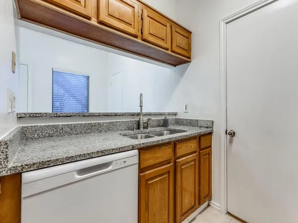 a kitchen with stainless steel appliances granite countertop a sink and cabinets