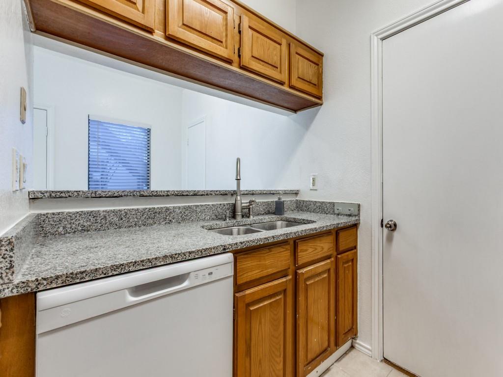 7340 Skillman Street, Unit 605 Dallas, TX 75231 - Photo 11 of 25 a kitchen with stainless steel appliances granite countertop a sink and cabinets