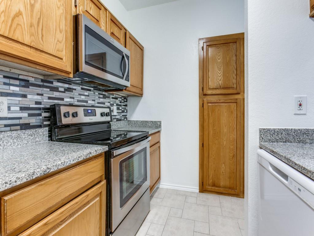 7340 Skillman Street, Unit 605 Dallas, TX 75231 - Photo 12 of 25 a kitchen with granite countertop cabinets stainless steel appliances and a counter space