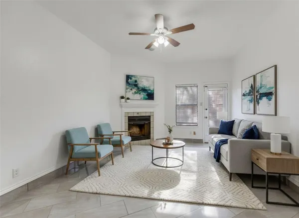 a living room with furniture and a fireplace
