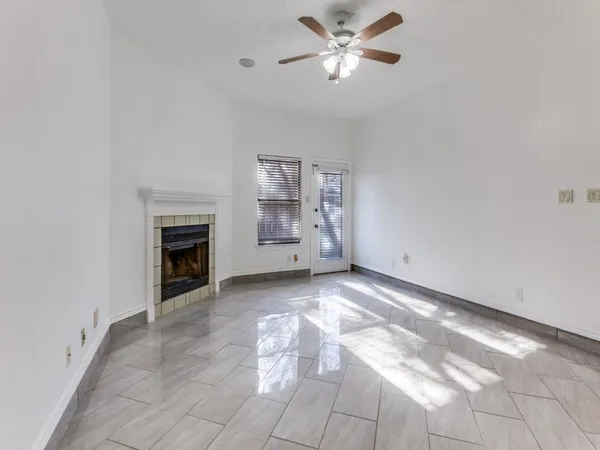 a view of empty room with a fireplace