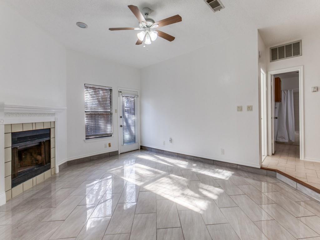 7340 Skillman Street, Unit 605 Dallas, TX 75231 - Photo 18 of 25 a view of a livingroom with a fireplace a ceiling fan and window