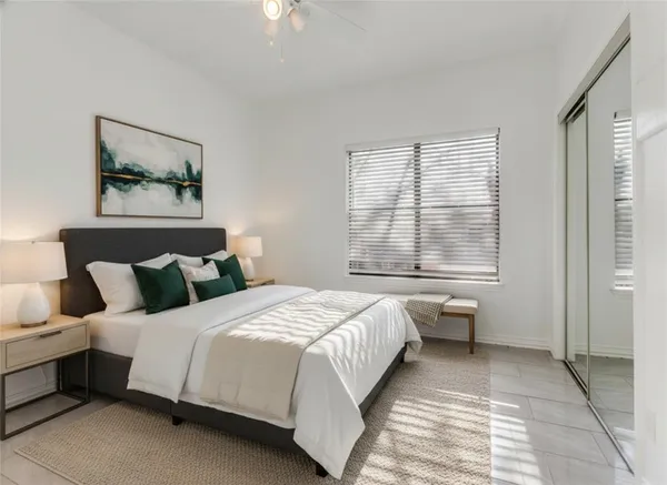 a bedroom with a large bed and a window
