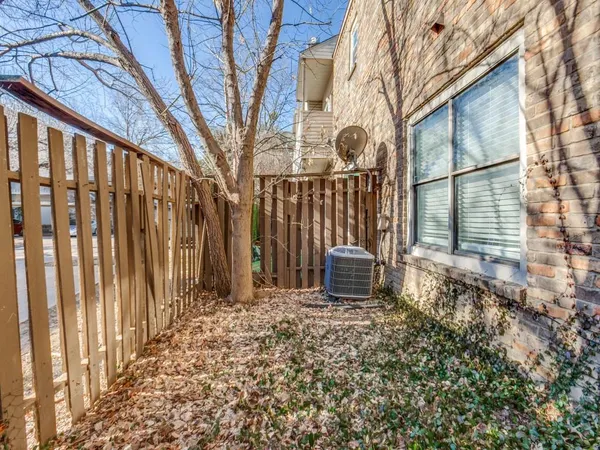 a view of a house with wooden fence and bench