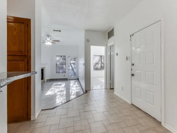 a view of a hallway with closet and bathroom