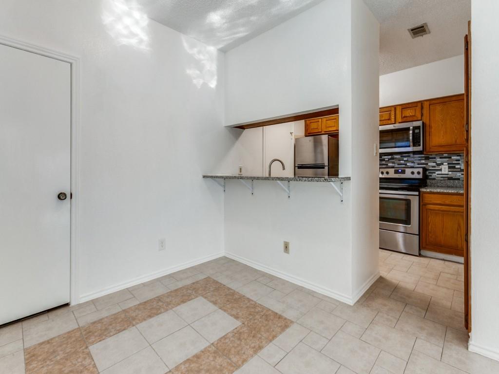 7340 Skillman Street, Unit 605 Dallas, TX 75231 - Photo 7 of 25 a kitchen with a stove and a refrigerator