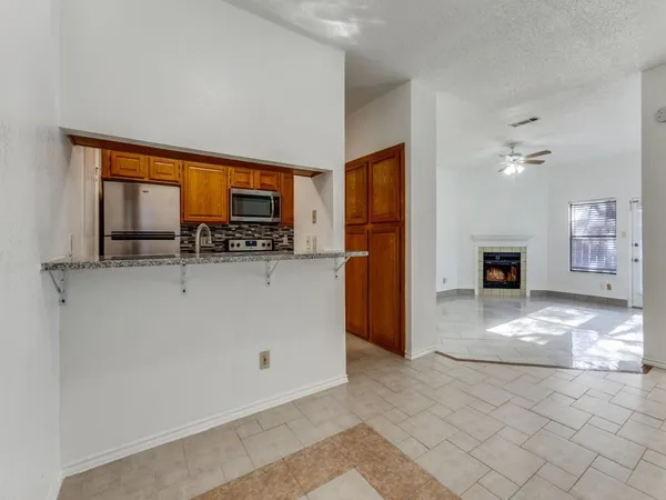 a view of kitchen with refrigerator and window
