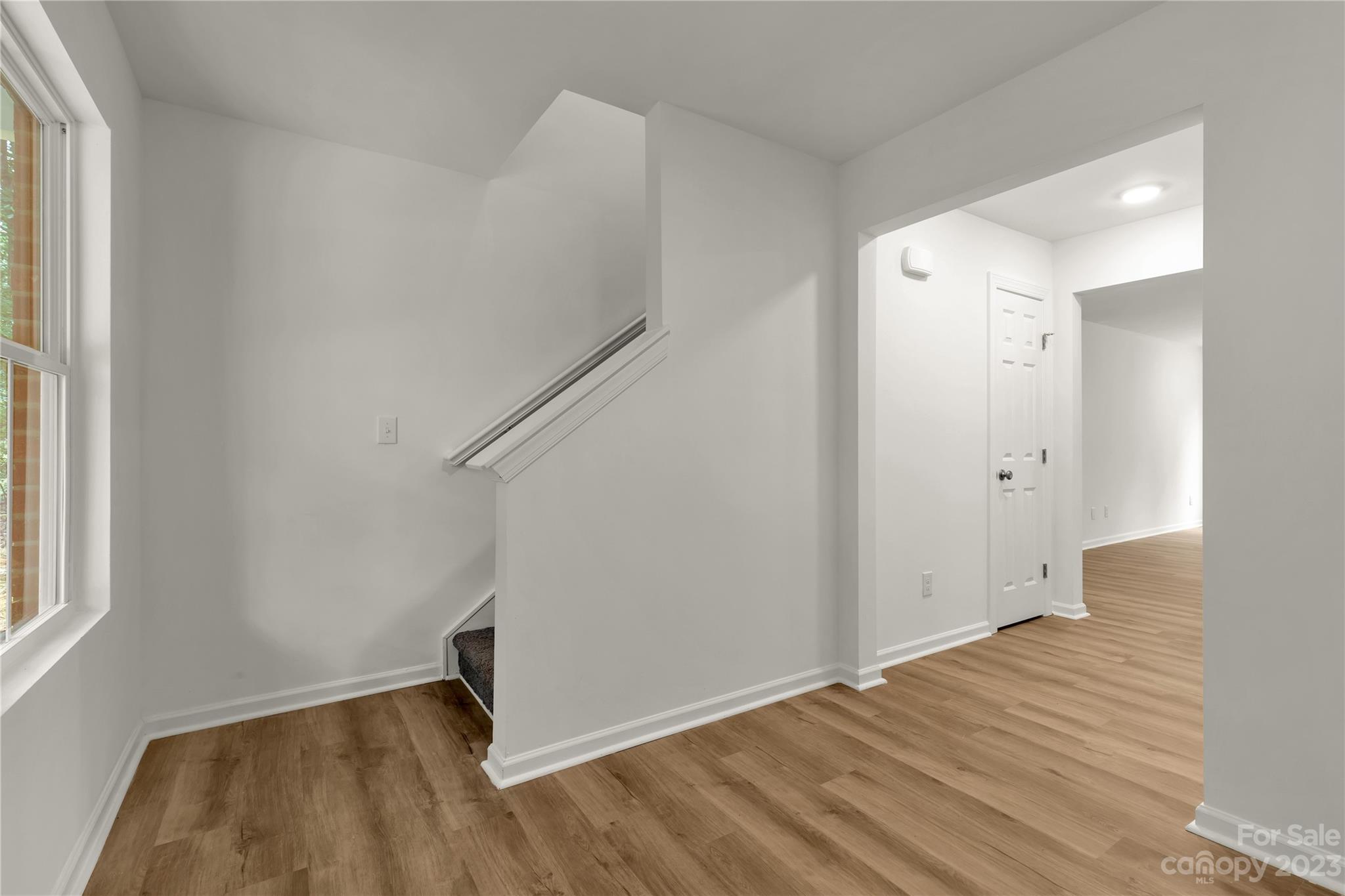 4081 Taxahaw Road Lancaster, SC 29720 - Photo 6 of 36 a view of an empty room with wooden floor and a window