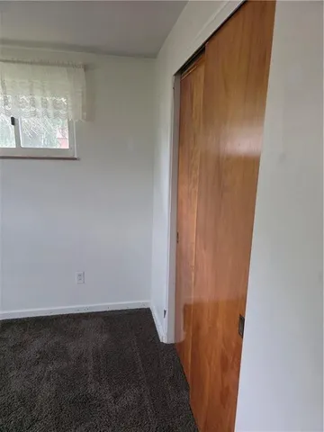 a view of a small space with wooden floor and staircase