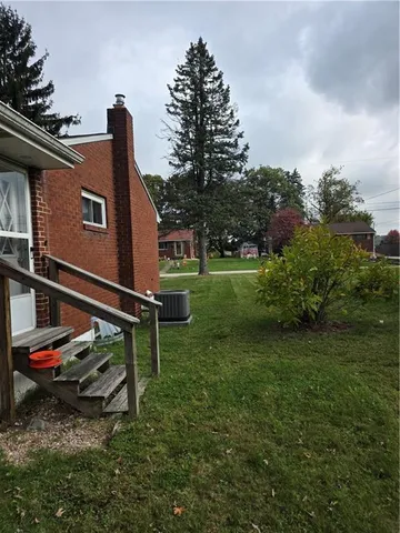 a view of outdoor space with deck and yard