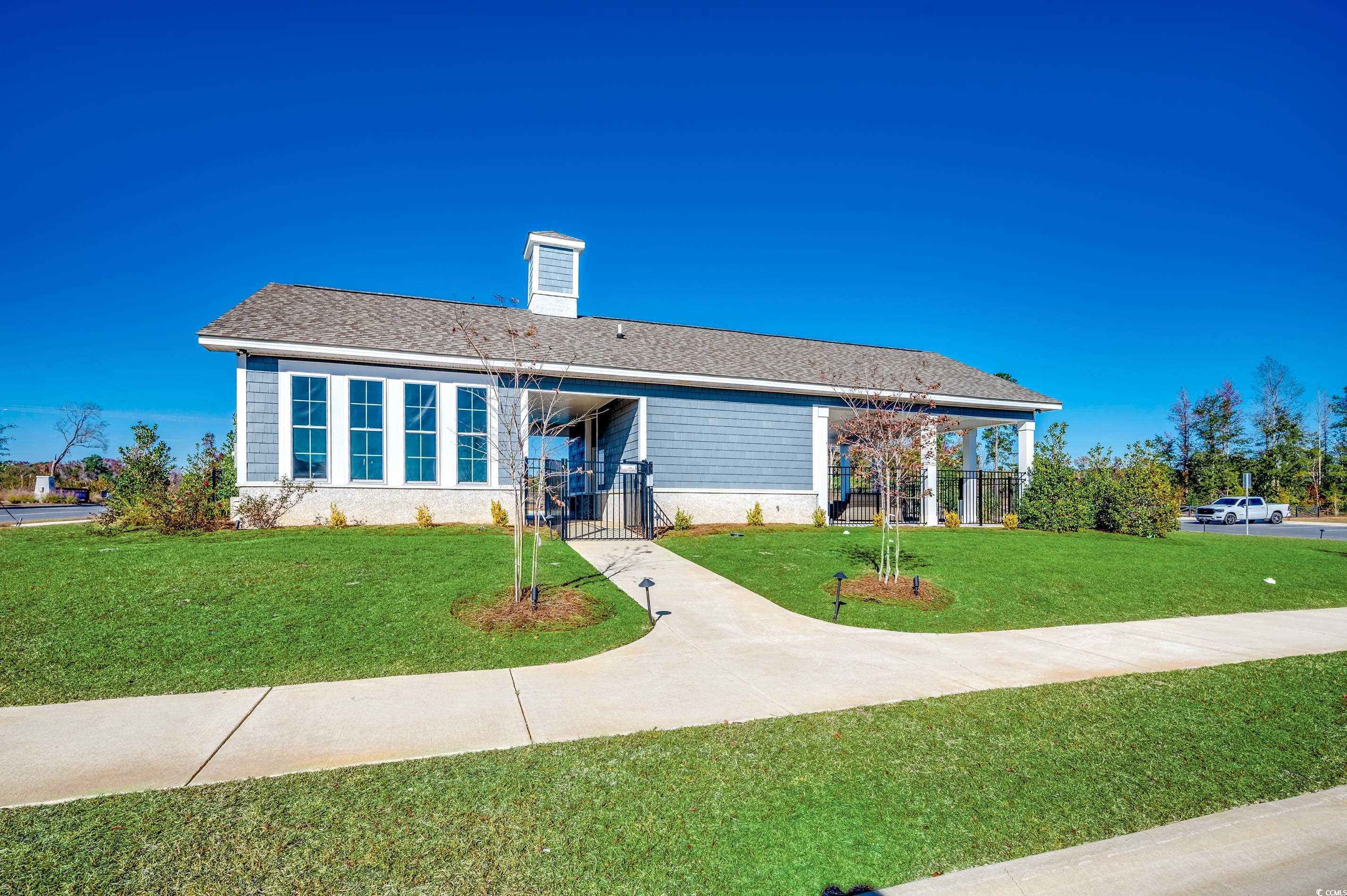 256 Country Grove Way Galivants Ferry, SC 29544 - Photo 22 of 22 View of front facade with a front lawn, a chimney, a gate, and a shingled roof