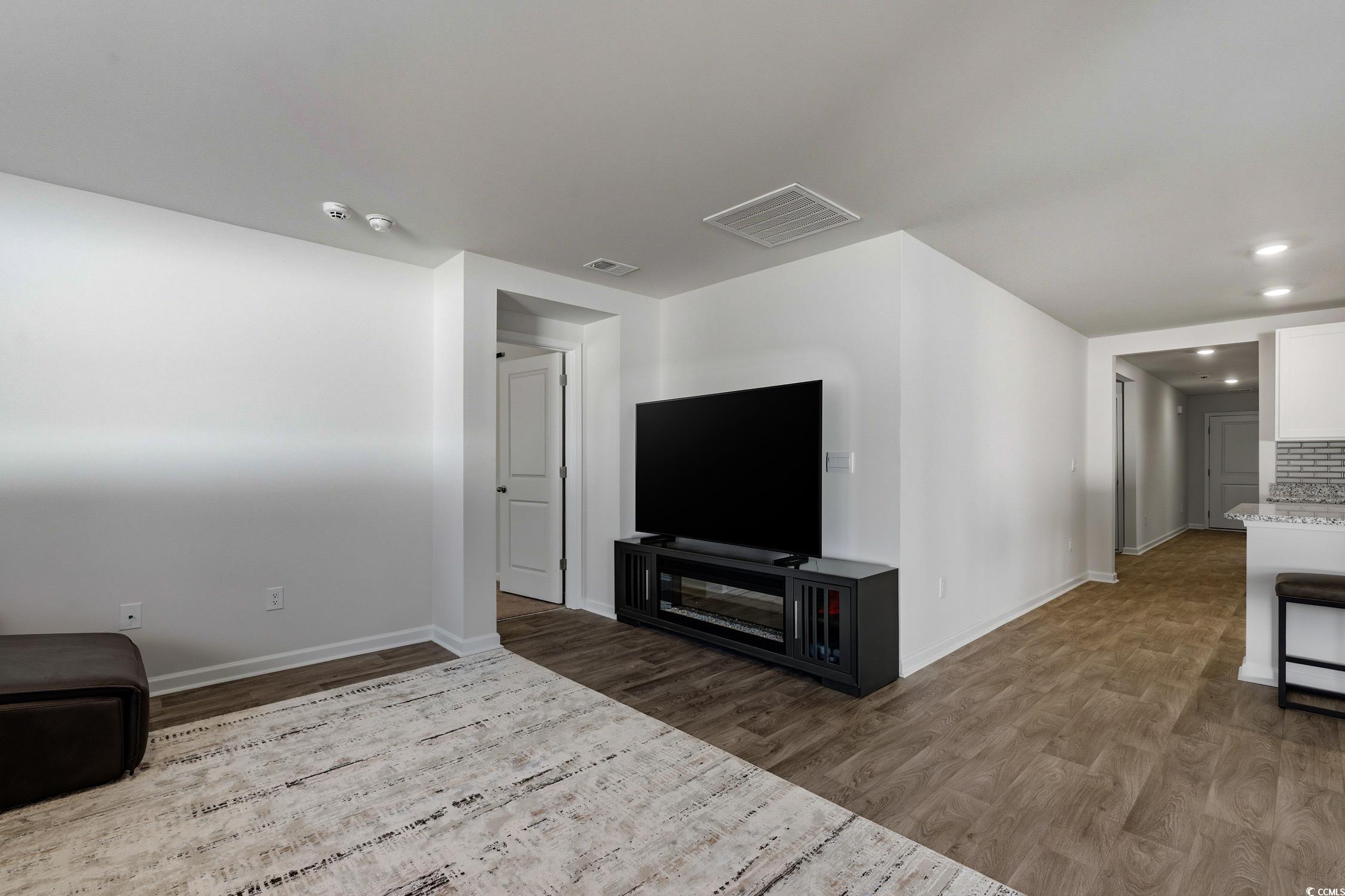 256 Country Grove Way Galivants Ferry, SC 29544 - Photo 7 of 22 Unfurnished living room featuring light wood-style floors and baseboards
