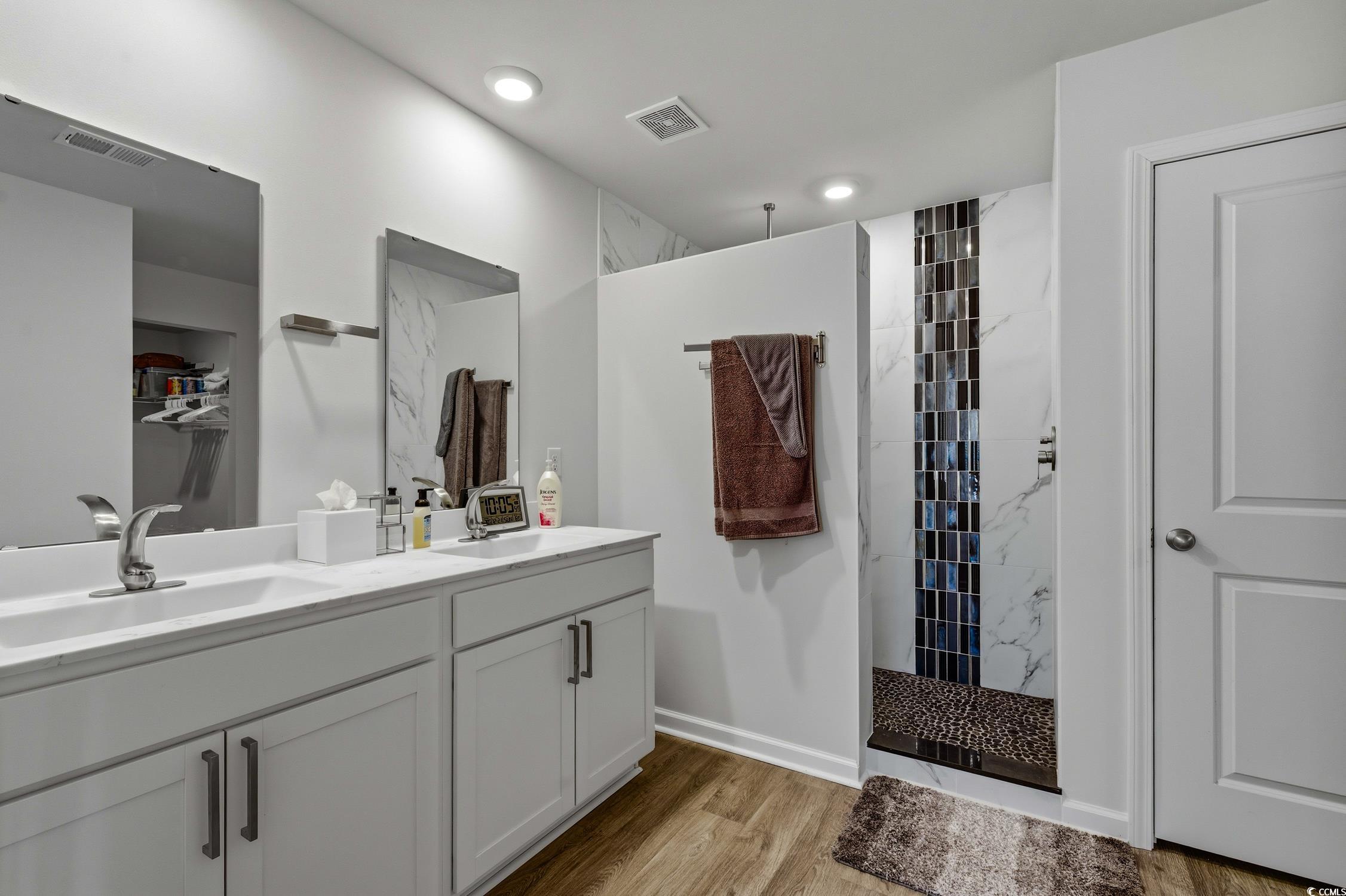 256 Country Grove Way Galivants Ferry, SC 29544 - Photo 10 of 22 Bathroom with a marble finish shower, double vanity, and light wood finished floors