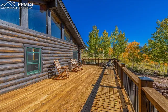 a view of a patio with table and chairs and wooden floor