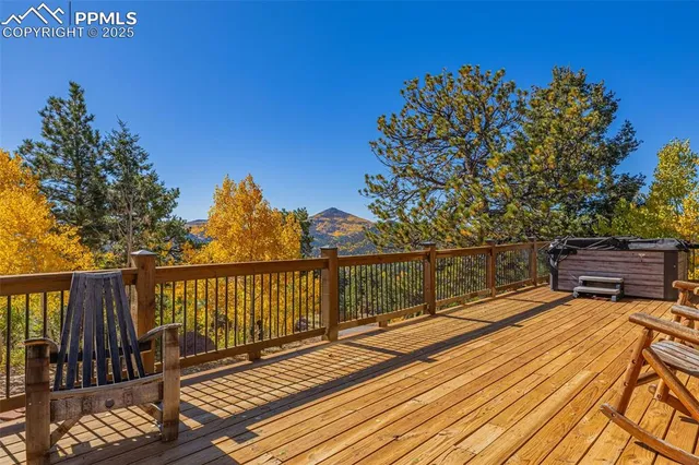 a kitchen with stainless steel appliances kitchen island granite countertop a table chairs and a refrigerator