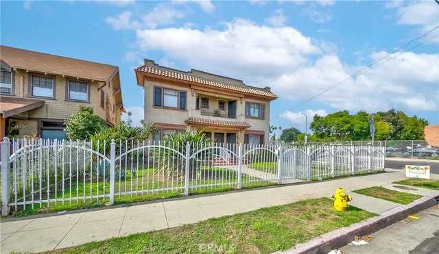 a view of a house with a backyard and a garden