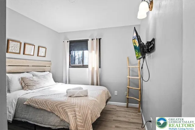 a bedroom with a bed and a chandelier