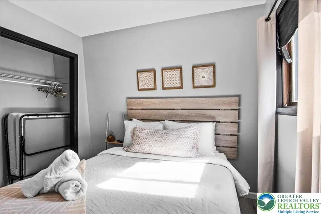 a bedroom with a bed and a window