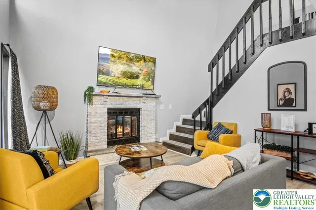 a living room with furniture and a fireplace