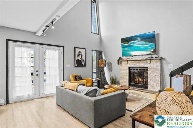 a living room with fireplace furniture and a flat screen tv