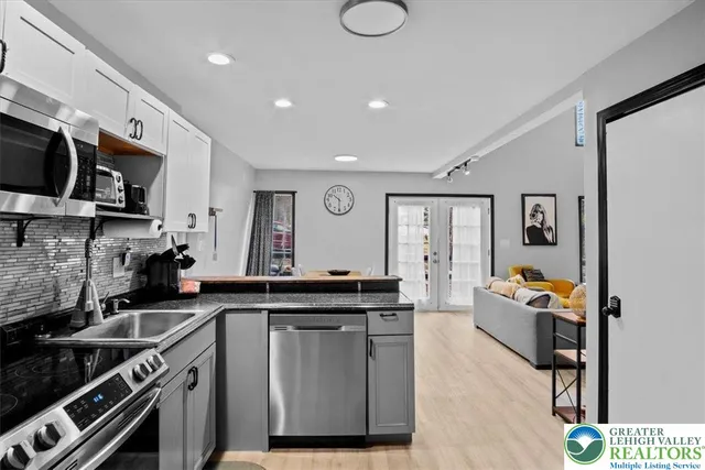a kitchen with stainless steel appliances granite countertop a stove and a sink