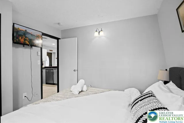 a bedroom with a bed and a painting on the wall