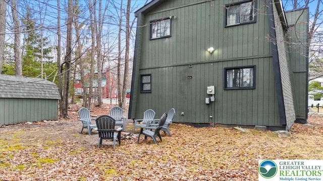 a backyard of a house with table and chairs