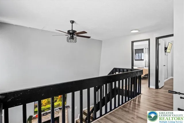 a view of a hallway with wooden floor