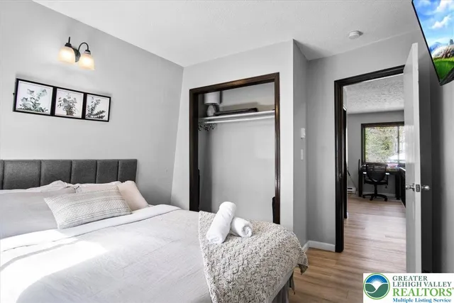 a bedroom with a bed and a large mirror