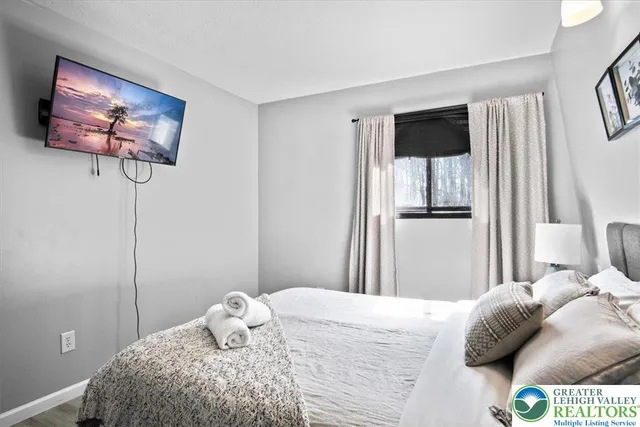 a bedroom with a bed and a tv