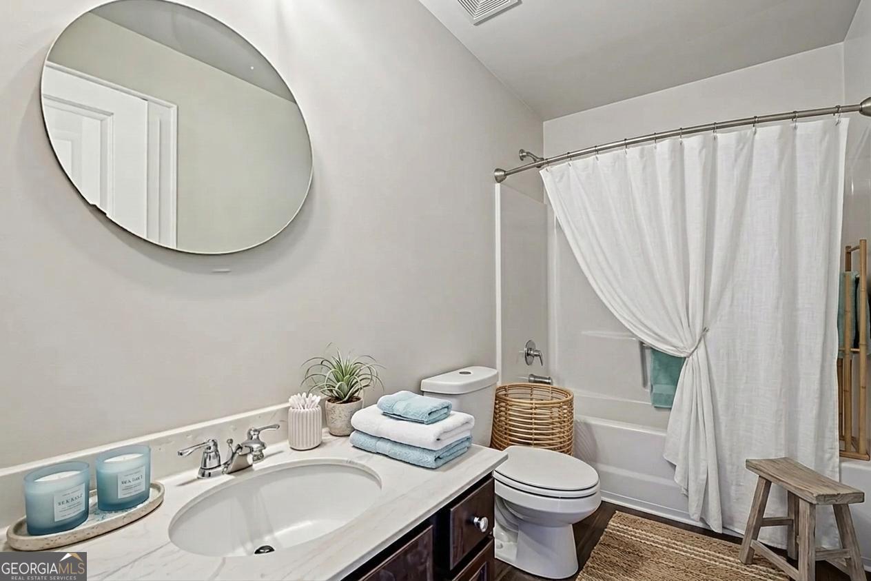 17 Lake Sydney Drive Dawsonville, GA 30534 - Photo 26 of 52 a bathroom with a sink a toilet and a mirror