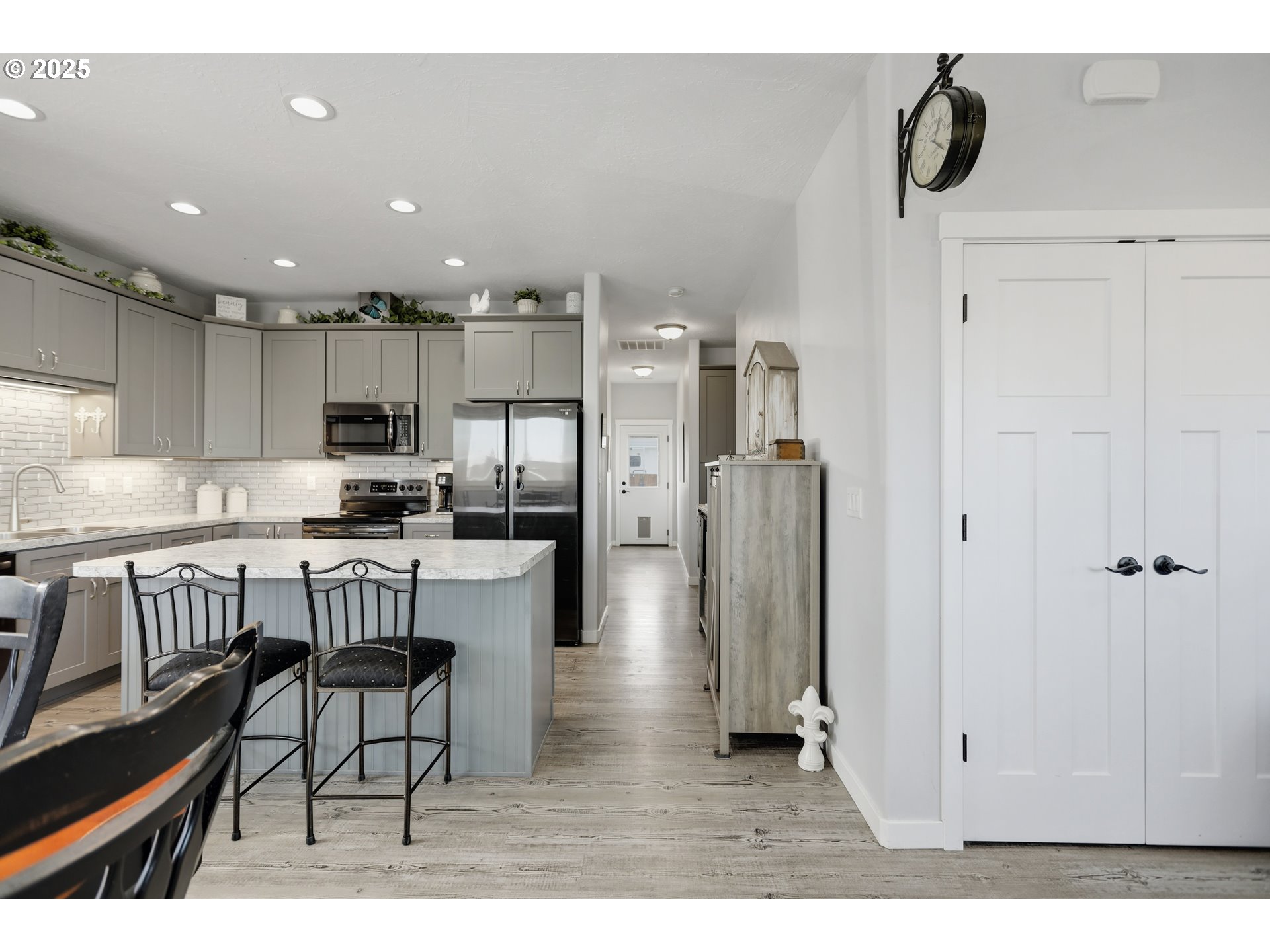 1275 Wright Road Arlington, OR 97812 - Photo 28 of 34 a kitchen with stainless steel appliances granite countertop a refrigerator a stove a sink dishwasher and white cabinets with wooden floor