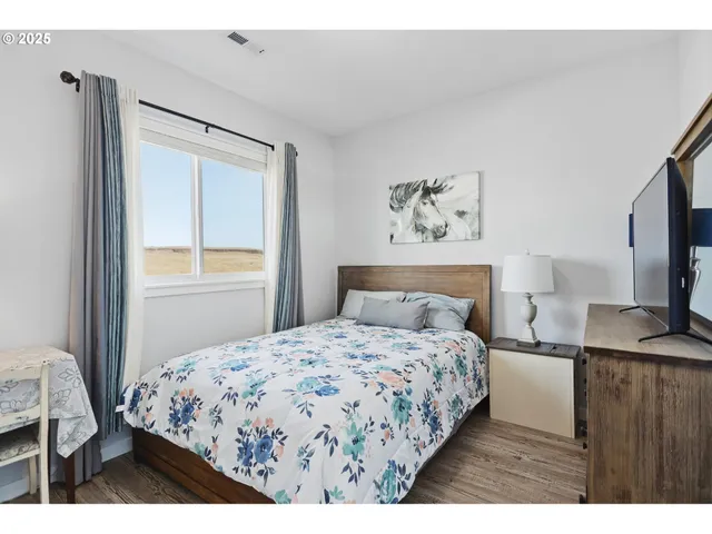 a bedroom with a bed and a flat screen tv