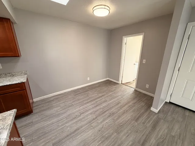 an empty room with wooden floor and closet