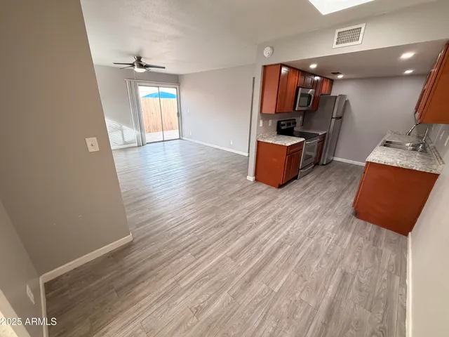a view of kitchen with furniture and wooden floor
