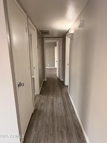 a view of a hallway with wooden floor