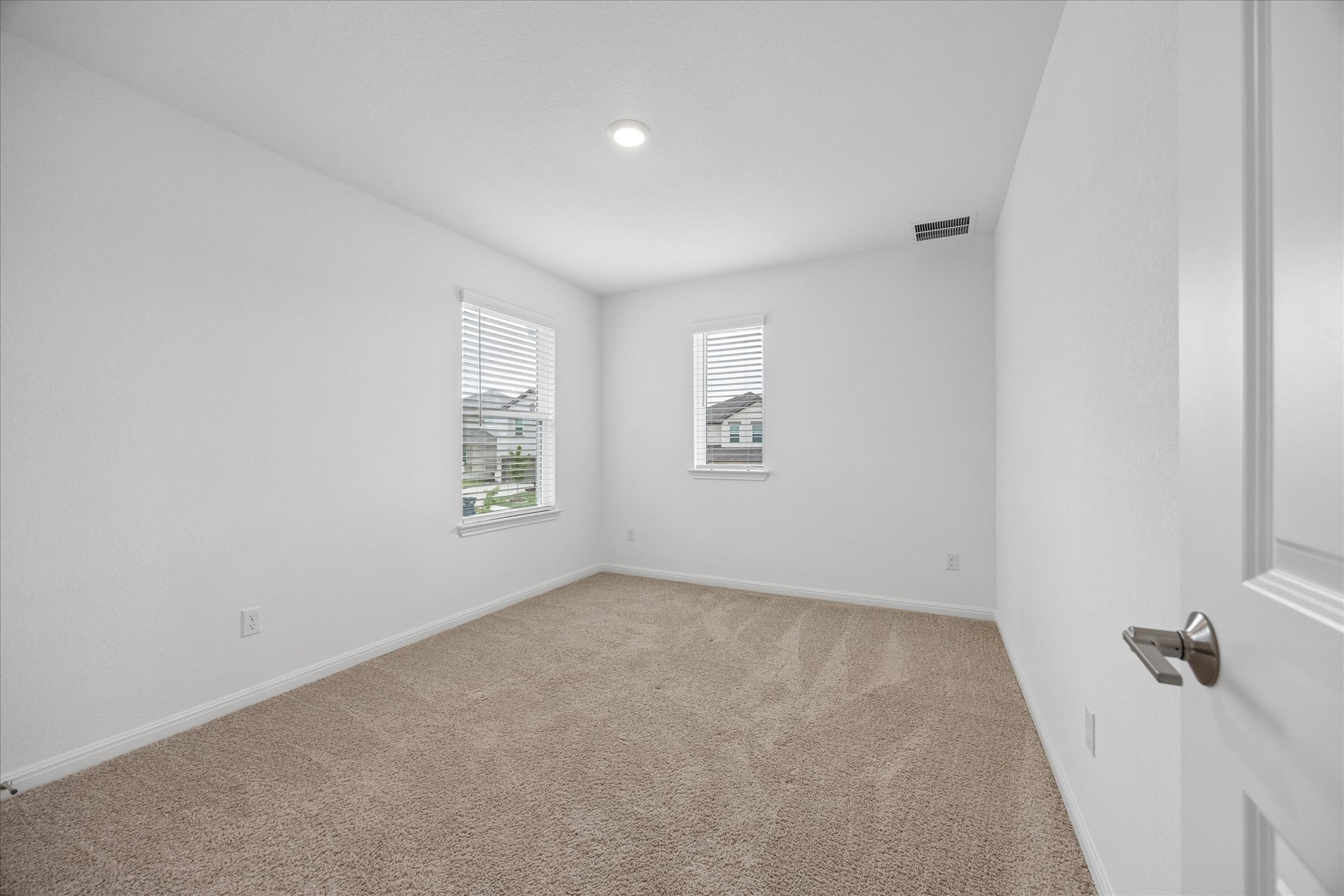 6407 Rounded Pebble Lane Buda, TX 78610 - Photo 23 of 32 A well-lit, neutral-toned room ready for personalized touches.