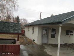 502 South Hennessy Road Yakima, WA 98908 - Photo 3 of 17 a backyard of a house with large tree and wooden fence