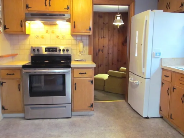 a kitchen with a stove and a refrigerator