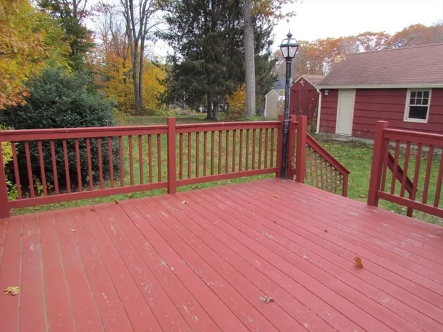 a view of a house with wooden deck