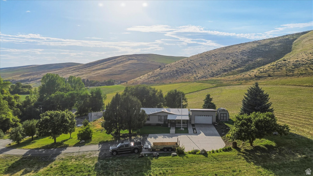 2405 Canyon Road Smithfield, UT 84335 - Photo 56 of 57 Single-story residence featuring a covered front porch, an attached garage, and a separate shed structure