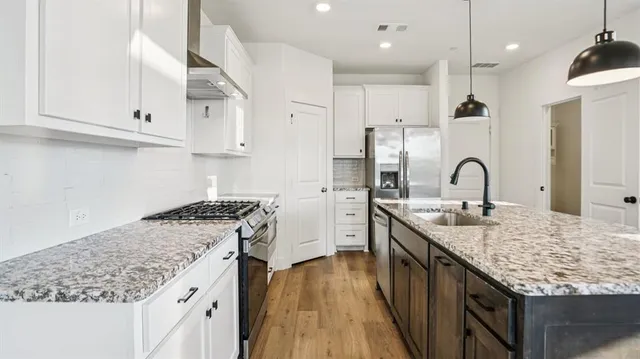 a view of a kitchen and wooden floor
