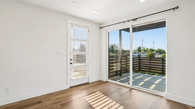 a kitchen with stainless steel appliances granite countertop a sink a stove and a wooden floors