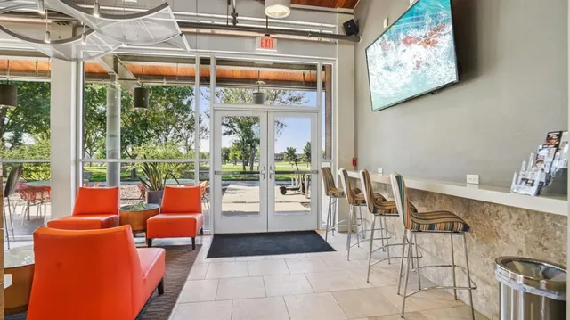 a dining room with furniture and a window
