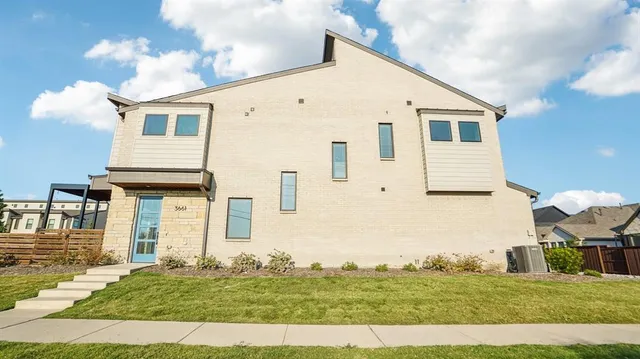 a view of a white house with yard